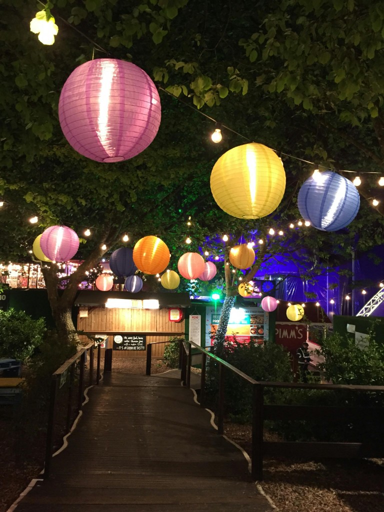 Outdoor private party walkway with colorful lanterns and string lights